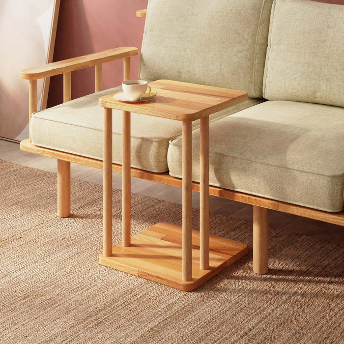 Solid Wood C Table next to a couch – A sleek and modern C-shaped side table made of solid wood, designed to slide under a sofa or chair for convenience.