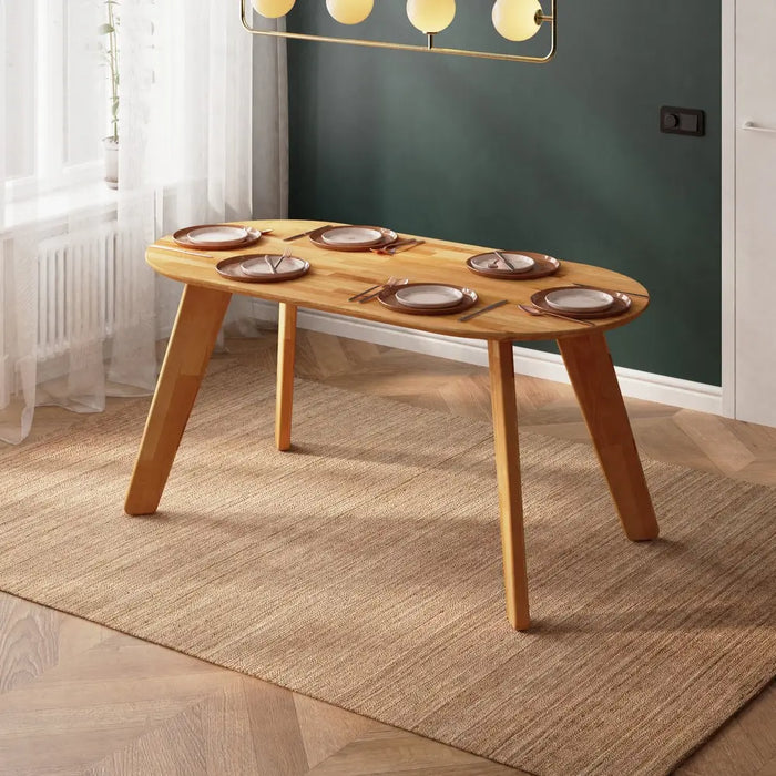 Elegant oval wood dining table with a smooth walnut finish, placed in a minimalist dining room.
