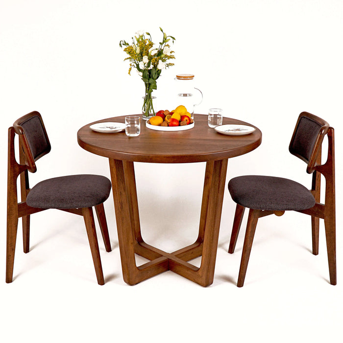 A dining setup featuring the Muse table, styled with tasteful decor and dinnerware