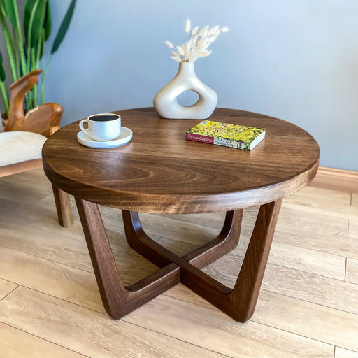 Solid wood round coffee table made from high-quality walnut, featuring a smooth, matte finish, mid-century modern design, and sturdy wooden legs, available in various sizes. Front top view