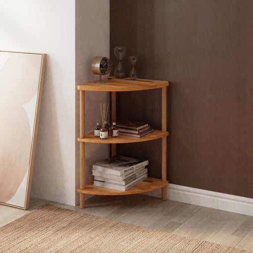 Full view of Webb Wood Corner Bookcase, showing all three shelves neatly filled with books and decor.