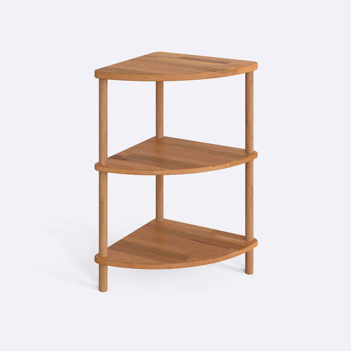 Side view of Webb Wood Corner Bookcase with three spacious shelves, placed in a modern living room corner