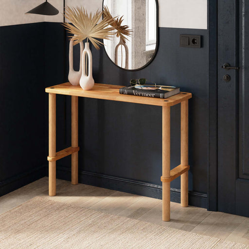 A sleek Anderson Narrow Console Table placed in a modern hallway, showcasing its solid wood construction and elegant design.