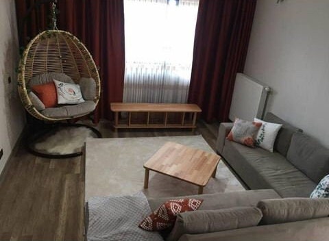 The Brooklyn Square Coffee Table styled in a modern living room, paired with decor and seating.