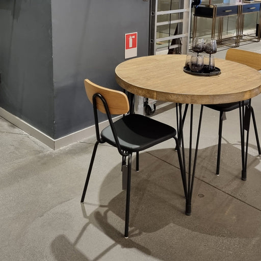 Concord Round Rustic Dining Table in farmhouse design, showcasing a seamless blend of pine wood top and iron legs, perfect for rustic and modern dining spaces.