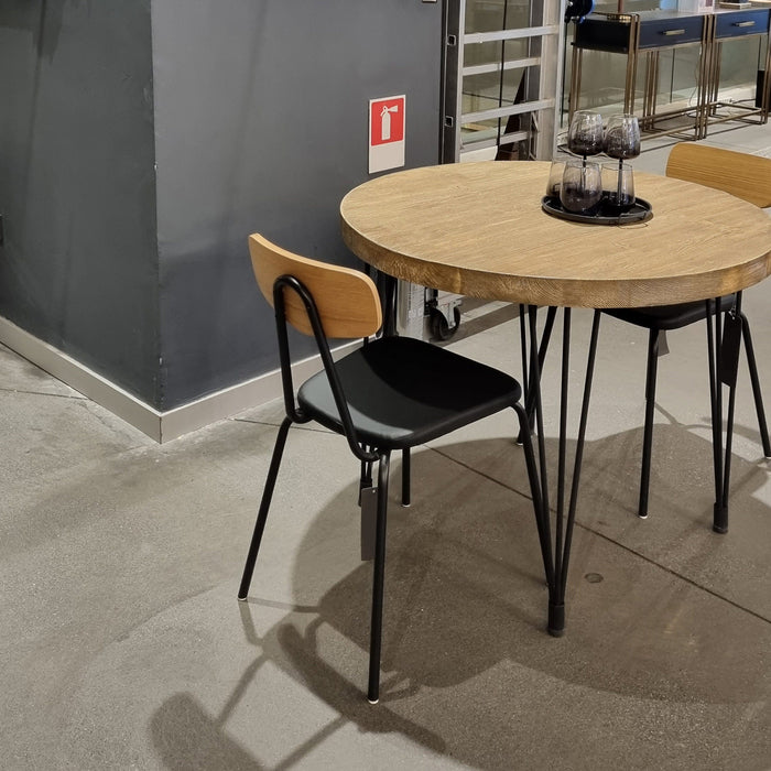 Concord Round Rustic Dining Table in farmhouse design, showcasing a seamless blend of pine wood top and iron legs, perfect for rustic and modern dining spaces.