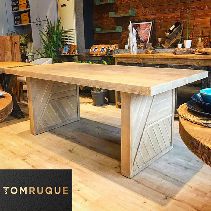 The spacious rectangular dining table in a rustic dining room setting, paired with matching wooden chairs to create a warm, inviting atmosphere.