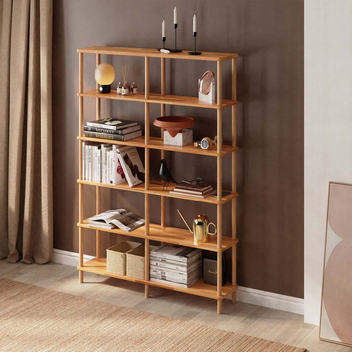 A tall and elegant natural wood bookcase with six spacious tiers, perfect for organizing books and decor.