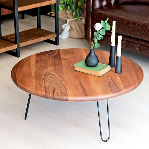 Front view of the Spark Walnut Wood Round Coffee Table – A sleek round coffee table crafted from solid walnut wood, featuring a rich natural finish and sturdy black metal legs.