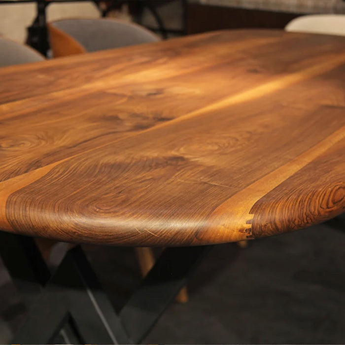 Detail shot of the table’s corner, focusing on the smooth finish and seamless joinery of the wooden surface.