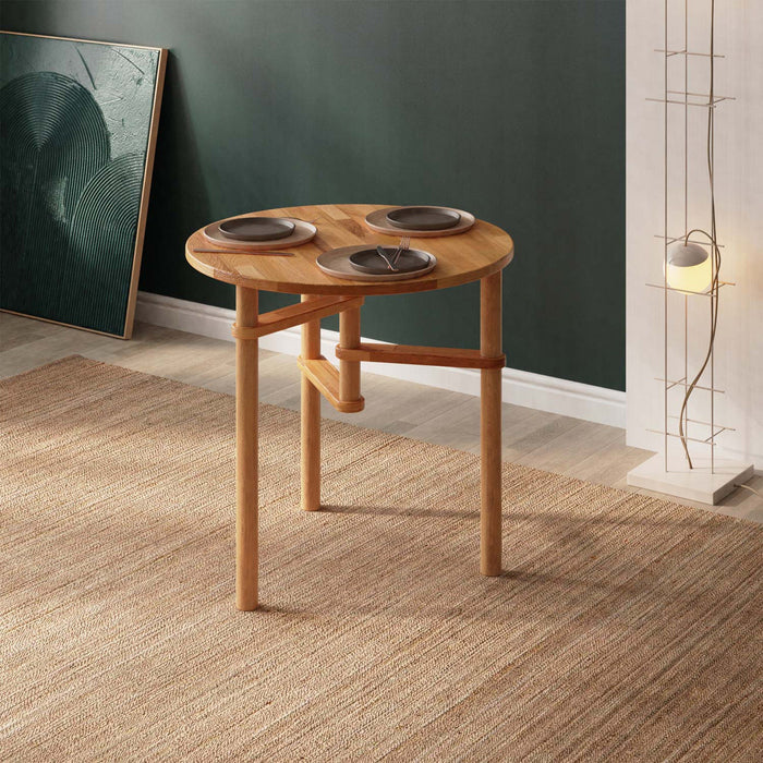 A minimalist solid wood small round dining table with a sleek design, showing a close-up view of its smooth surface and natural wood grain.