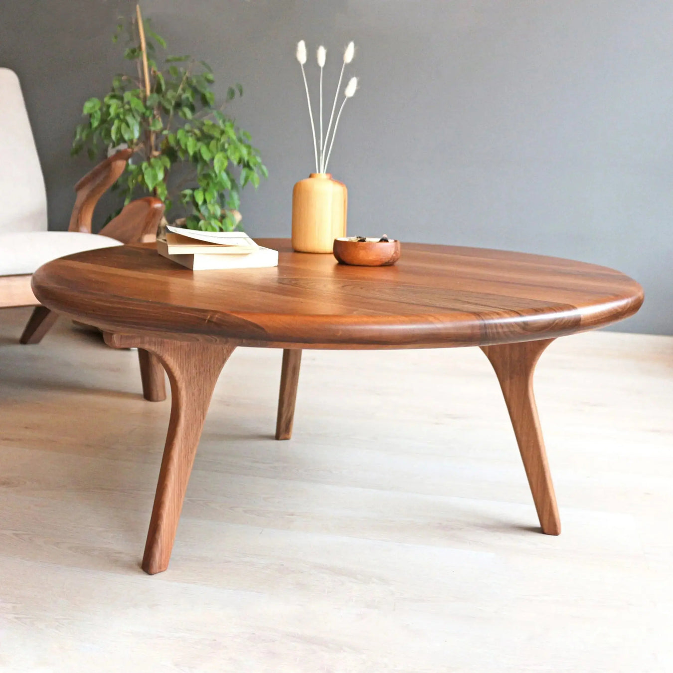 Sidney Round Coffee Table made from solid walnut wood, featuring a sleek mid-century modern design. Perfect for adding elegance to any living space, ideal for those seeking solid wood coffee tables.