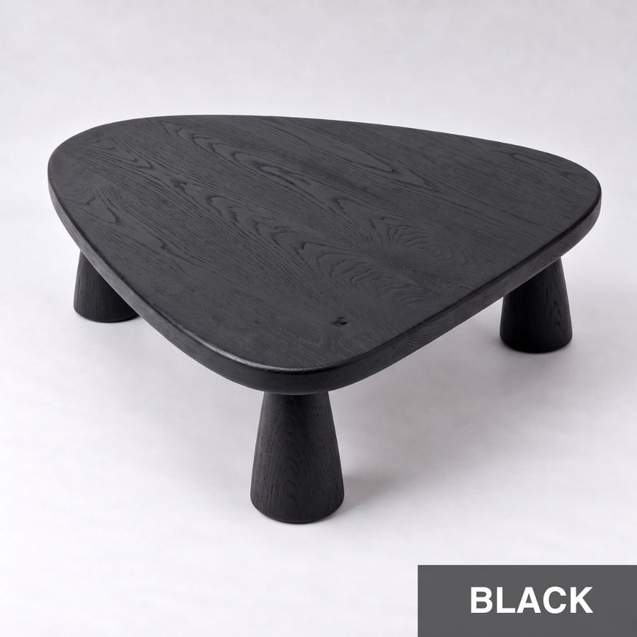 Yuma Organic Triangle Beech Wood Coffee Table with a black wood grain finish, featuring a rounded triangular top and three tapered cylindrical legs, shown on a light gray background with a 'BLACK' label in the bottom right corner.