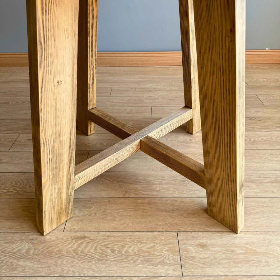 Wide shot of the Amber Round Farmhouse Dining Table in a modern farmhouse dining setting.