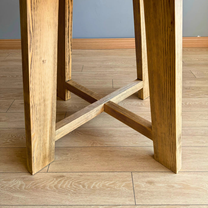 Wide shot of the Amber Round Farmhouse Dining Table in a modern farmhouse dining setting.