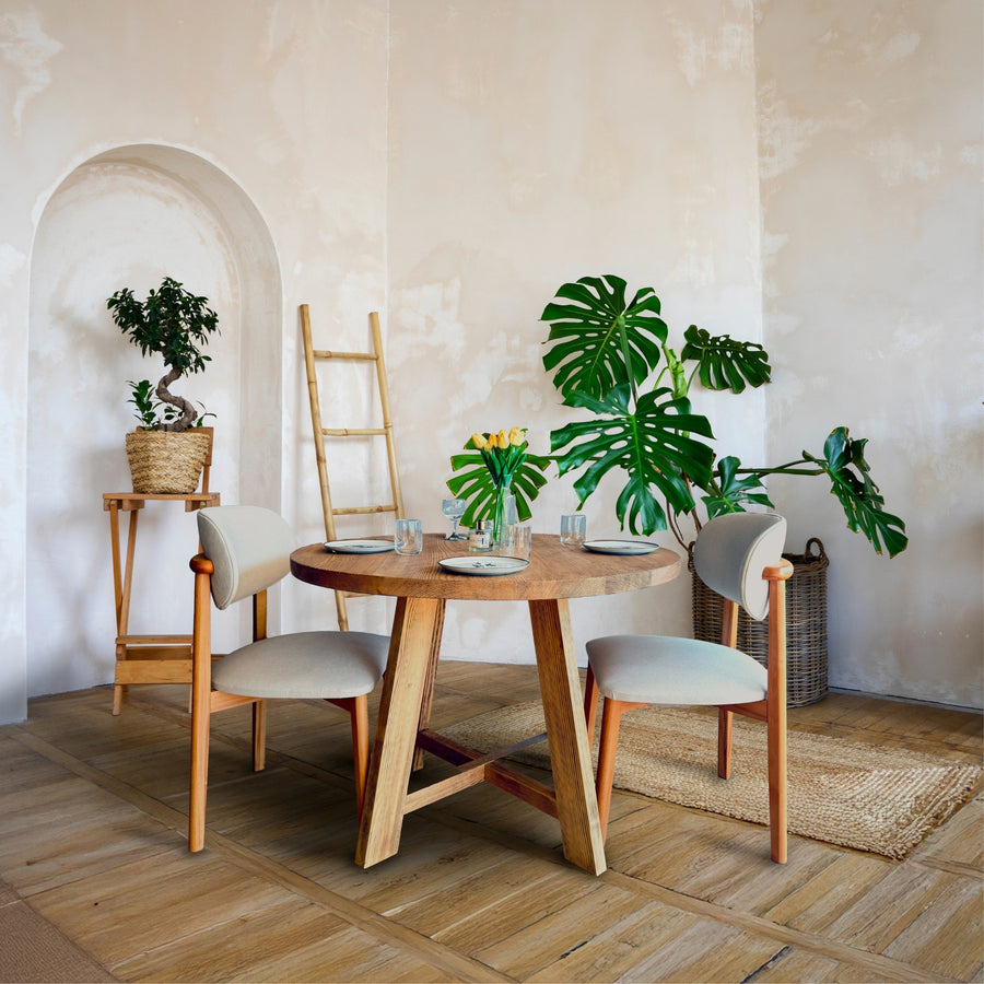 Full view of Amber Round Farmhouse Dining Table in a bright dining room.