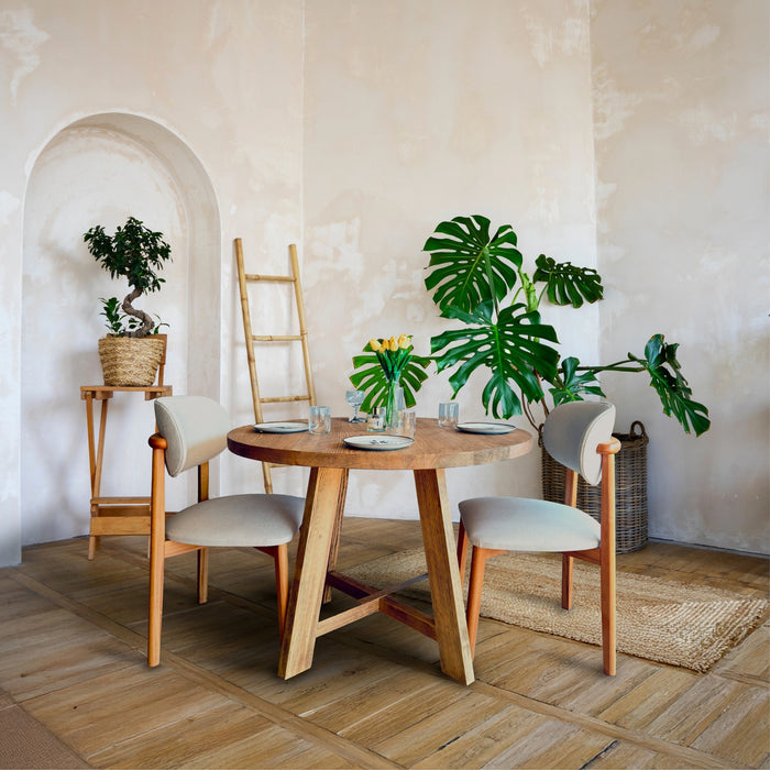 Full view of Amber Round Farmhouse Dining Table in a bright dining room.