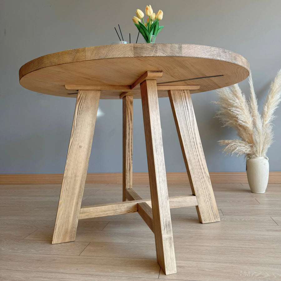 Close-up of the Round Dining Table's hand-finished surface.