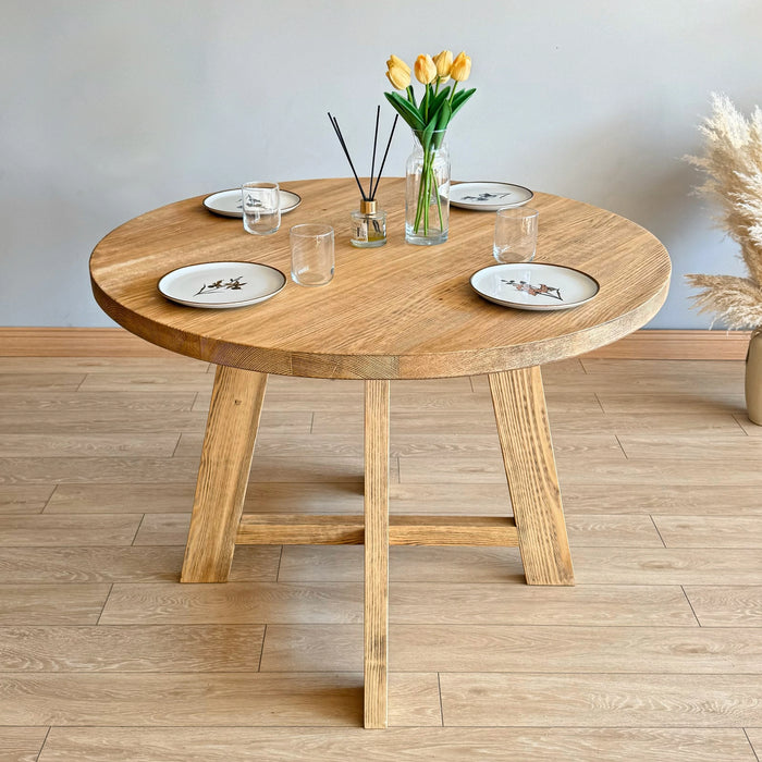 Amber Round Farmhouse Dining Table with different wood finish options, demonstrating versatility.