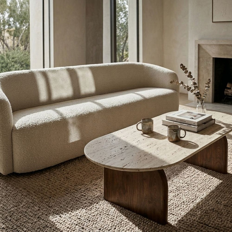 Arden Oval Travertine Coffee Table with Walnut Base - Sculptural Mid-Century Design Styled with Cream Bouclé Sofa by Tomruque