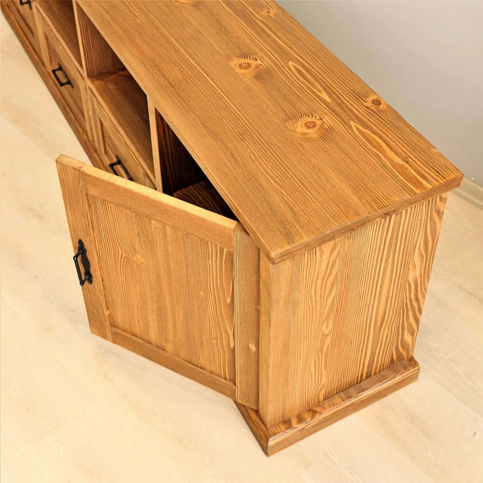 Wide-angle image of the wood TV stand in a cozy farmhouse-style living room.