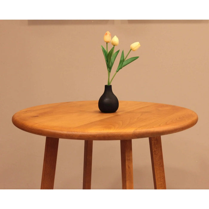 Close-up of the mid-century wooden leg design of the Axis Dining Table, crafted from solid beech wood