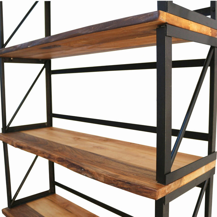 Wide-angle photo of the Band Walnut Bookcase in a living room, blending rustic and industrial styles in a home setting.