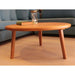 Bliss round wood cocktail table shown with a cozy seating arrangement, highlighting its durable wood craftsmanship.