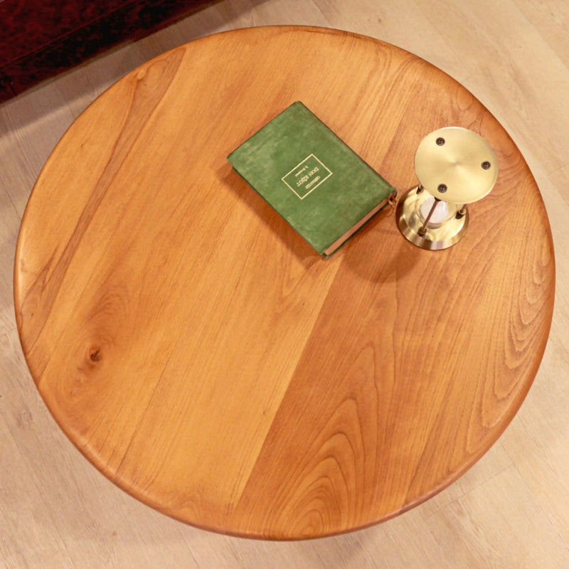 Top view of the Bliss round wood cocktail table showcasing its elegant circular design and polished surface.