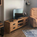 Angled side view showcasing the sturdy craftsmanship and smooth wooden finish of the TV stand.
