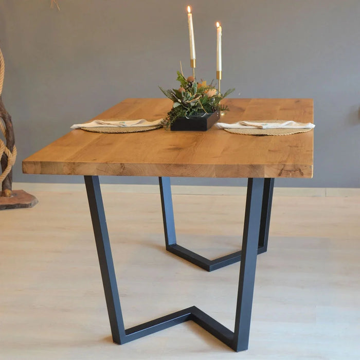 Close-up of oak dining table surface showcasing the natural grain finish and smooth texture.