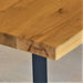 Side view of the dining table, highlighting its sturdy frame and elegant design