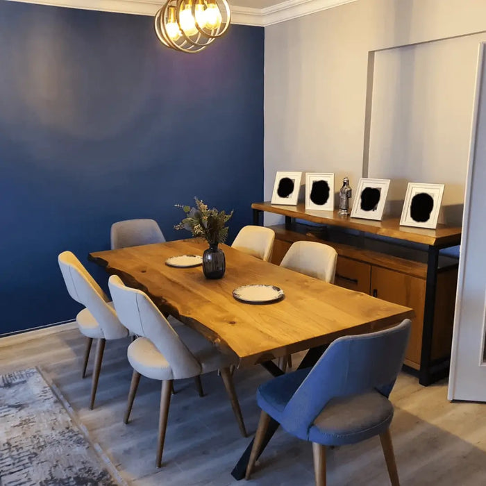 Wide shot of the dining room featuring the table, styled with chairs and decor for a complete look.