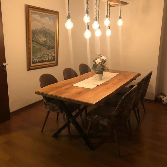 Angled shot of the walnut dining table set with tableware, showing its functional elegance in a dining room.