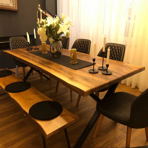 A walnut dining room table with a live edge design in a bright dining area, emphasizing its modern aesthetic.