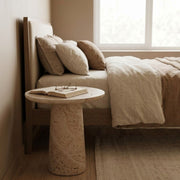 Dune Round Travertine Side Table - Sculptural Tapered Pedestal Design Styled as a Bedside Nightstand by Tomruque
