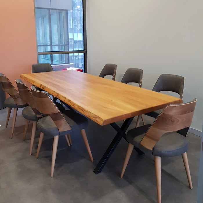 The table surrounded by chairs, demonstrating seating capacity and versatility.