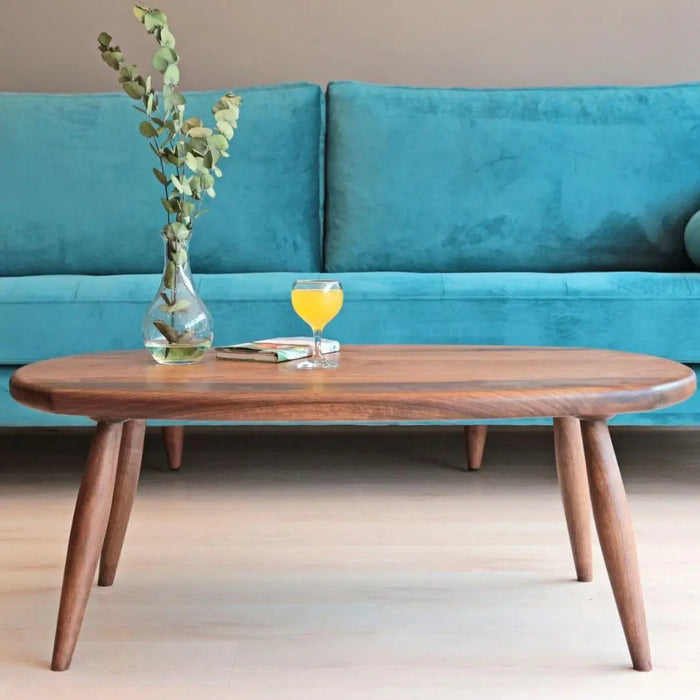 Front view: The combination of the blue sofa, parquet floor, and clear visibility of the table legs