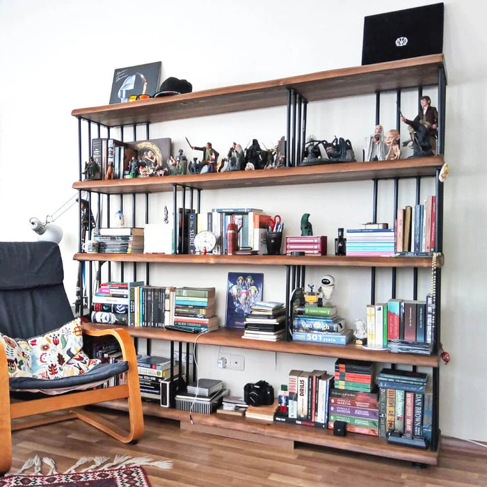 Fargo Solid Wood Bookcase with books, plants, and decorative items on its spacious shelves, enhancing the room's aesthetic.