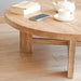 A side view of the Harlow round coffee table showcasing its solid construction and smooth wood surface.