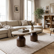 Koffel Oval Travertine Coffee Table with Walnut Wood Base - Sculptural Organic Modern Design Styled in a Warm Living Room by Tomruque