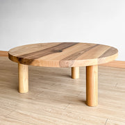 Light walnut wood round coffee table with warm texture and color