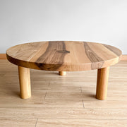 Minimalist round wood coffee table with its warm natural grains