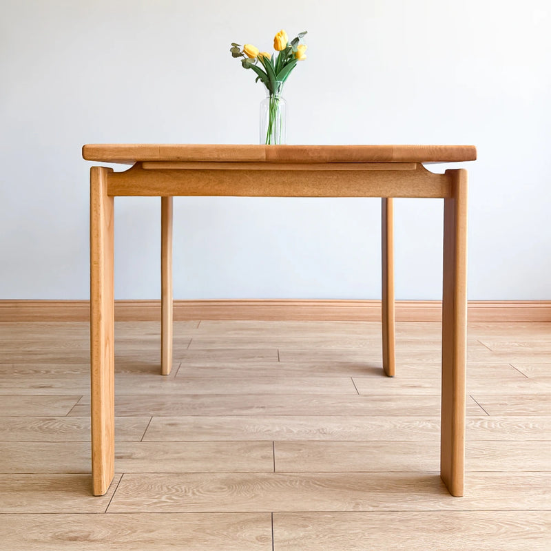 Front view of hte handcrafted solid wood square dining table with modern minimalist design