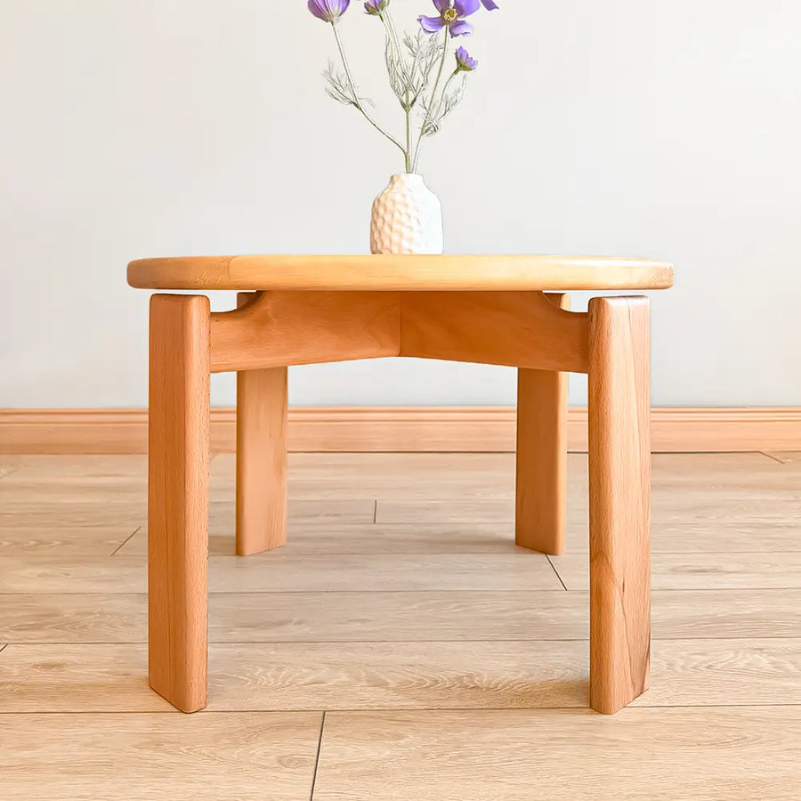 The table positioned next to a cozy sofa, illustrating its ideal size and functionality in a stylish living space.