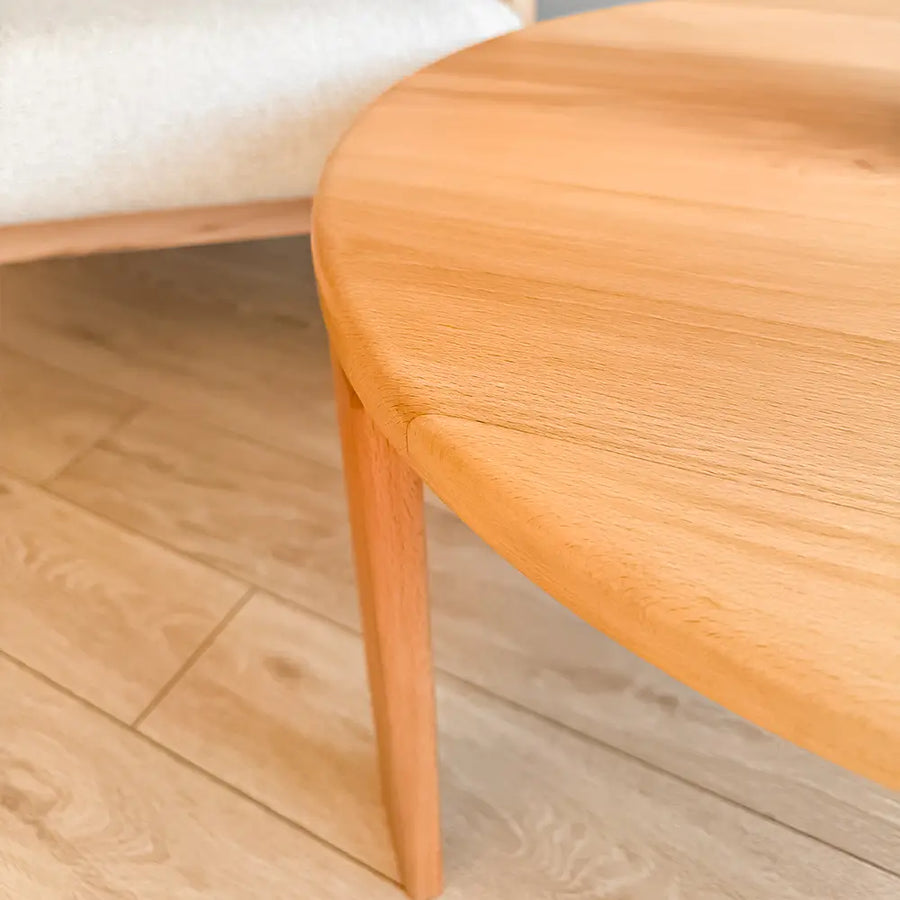 The Luna Minimalist Round Coffee Table styled with books and a decorative tray, enhancing a modern aesthetic.