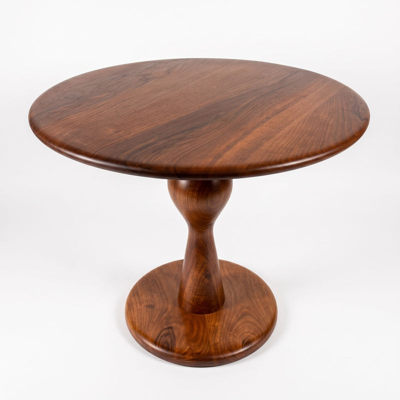 Mason Solid Walnut Round Pedestal Dining Table | Sculptural Base
 with a rich dark brown wood grain finish, photographed on a clean white background.