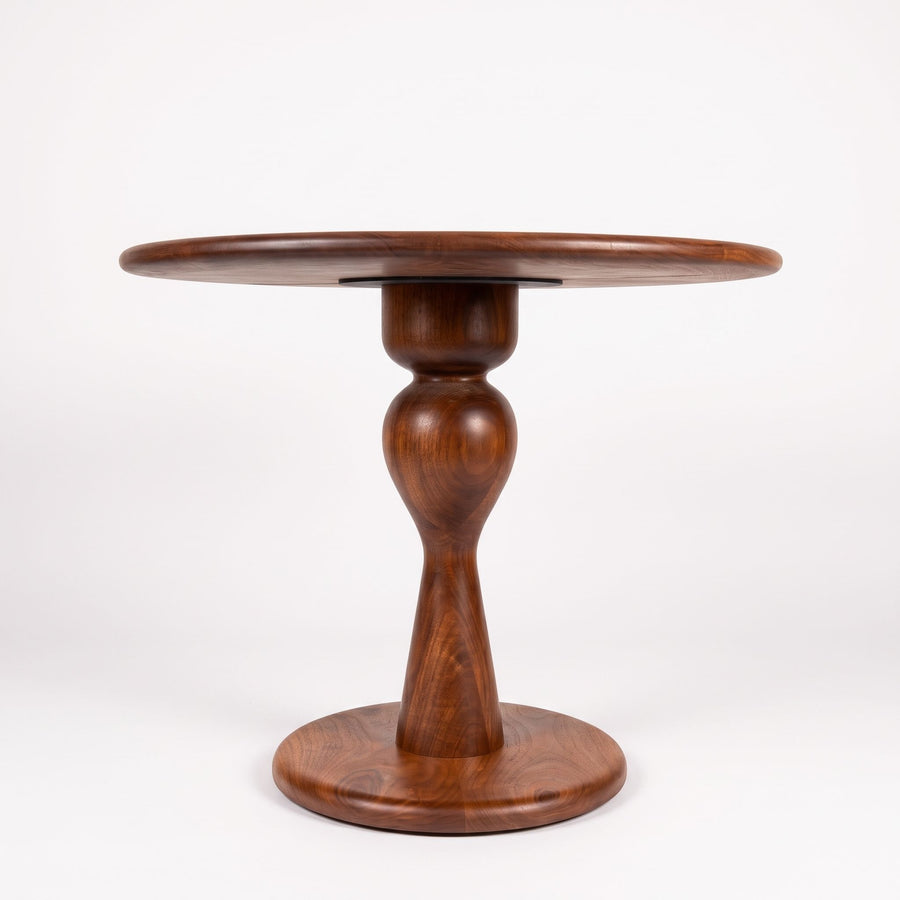 Mason Solid Walnut Round Pedestal Dining Table | Sculptural Base
 with a glossy dark brown finish, featuring a flared base and a decorative swan-neck style pedestal, photographed against a seamless white background.