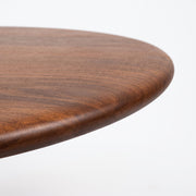 Close-up of Mason Solid Walnut Round Pedestal Dining Table | Sculptural Base
 tabletop edge with a rich medium-brown wood grain finish, set against a clean white background.