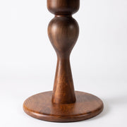Close-up ofMason Solid Walnut Round Pedestal Dining Table | Sculptural Base
 pedestal base with a round foot and bulbous center, showing the wood grain against a white background.